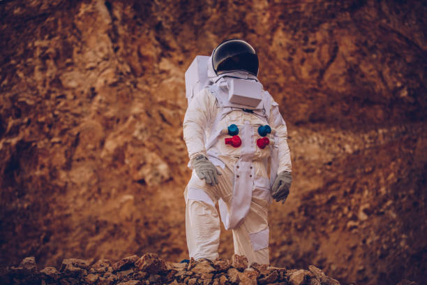 istock Astronaut standing among rock on Mars alone 1200926279
