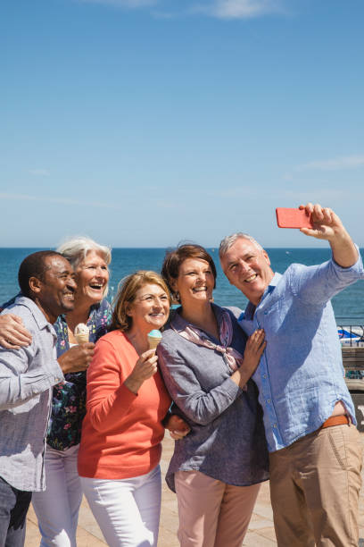 istock Cheerful seniors taking selfie on seaside holiday 1200927818