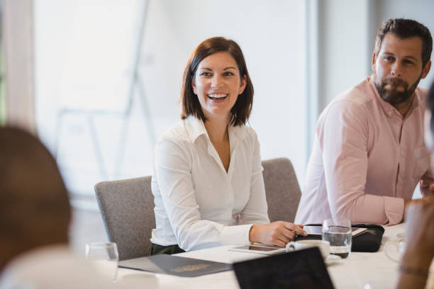 mujer alegre en la reunión de negocios con colegas - brainstorming team learning business fotografías e imágenes de stock