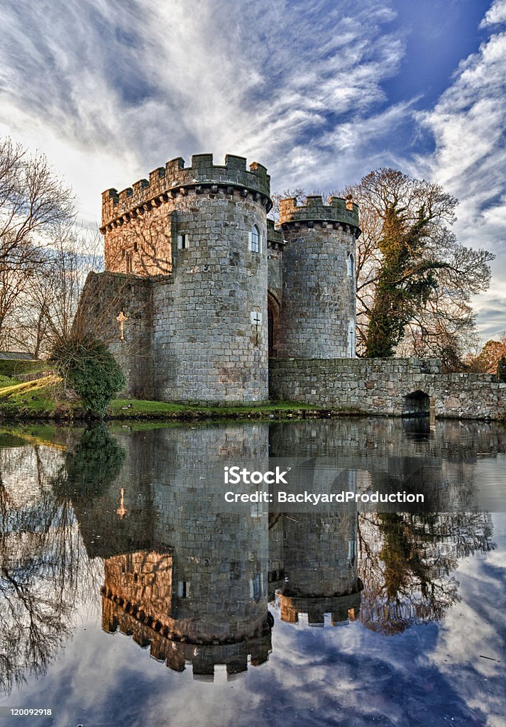 Whittington Castle in Shropshire reflecting on moat Ancient Whittington Castle in Shropshire, England reflecting in a calm moat round the stone buildings and processed in HDRAncient Whittington Castle in Shropshire, England reflecting in a calm moat round the stone buildings and processed in HDR British Culture Stock Photo