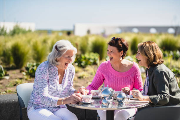 istock Senior women enjoying afternoon tea and laughing 1200929457