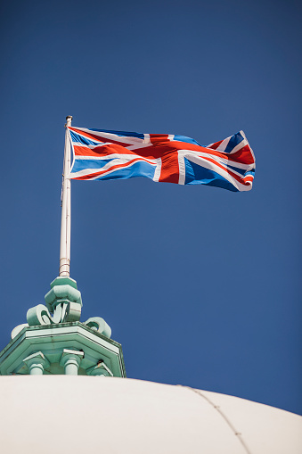 Union flag flapping in breeze on sunny day, symbol, national flag, patriotism, typically British