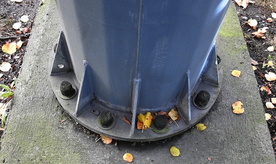 Lamp post bolted to the pavement.