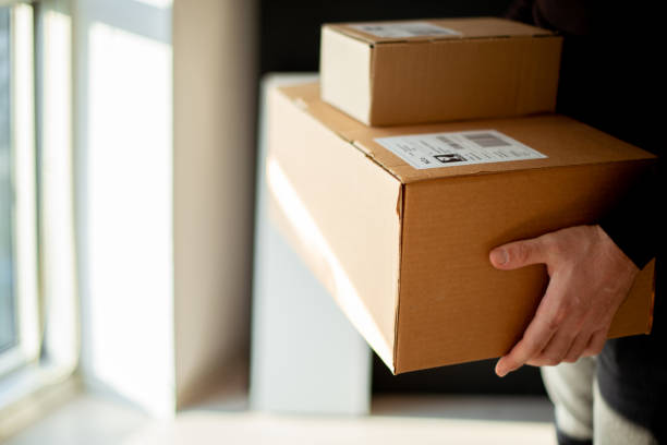 istock Young man carrying packages for shipment 1200932581