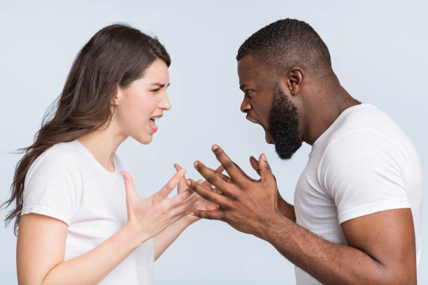 istock Multiracial couple quarreling, shouting at each other, having relationship problems 1200932611