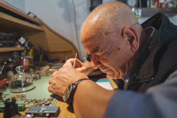 istock Watchmaker repairing old watch 1200933397