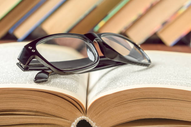 istock Glasses for vision lie on an open book, general education concept 1200935548