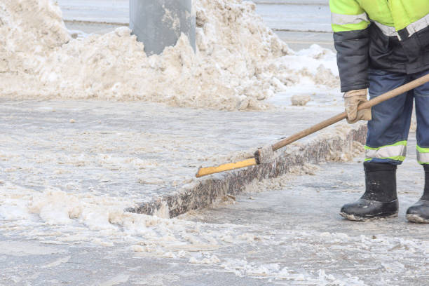 istock Worker clears the sidewalk from snow in winter 1200935609