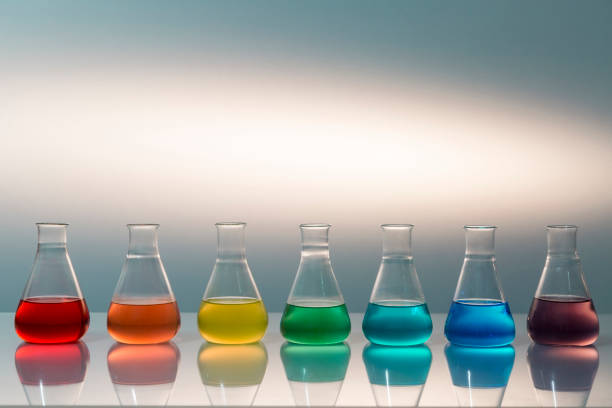 istock Scientific laboratory glass erlenmeyer flask filled with colorful liquid forming rainbow. 1200936052