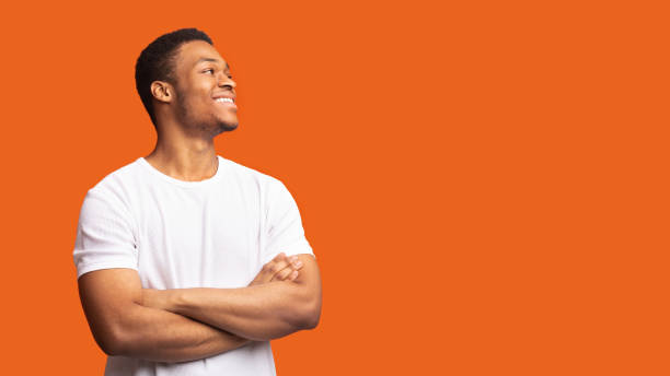 istock Smiling black man profile portrait on orange background 1200936065
