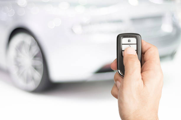 istock Hand of man holding and push remote control car open the door or  central locking technology transportation safety sale buy car concept 1200936366