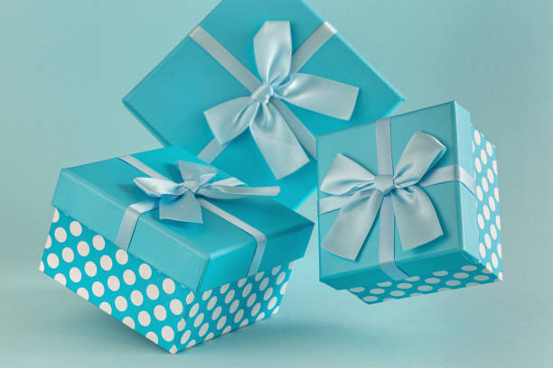 holiday handmade paper present tied blue ribbon bow top view with copy space. Flat lay holiday background. Birthday or christmas present. Christmas gift box concept with copy space.