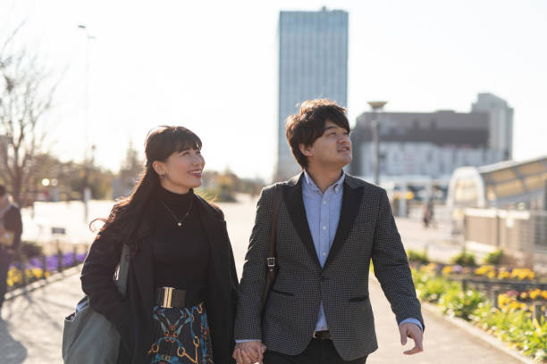 istock Married couple walking on street with holding hands 1200937207