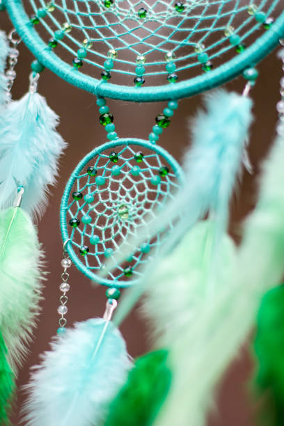 istock Handmade dream catcher with feathers threads and beads rope hanging 1200937286