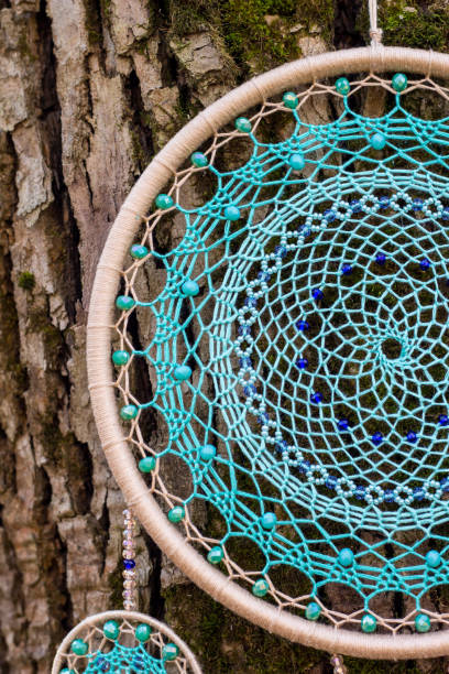 istock Handmade dream catcher with feathers threads and beads rope hanging 1200937300