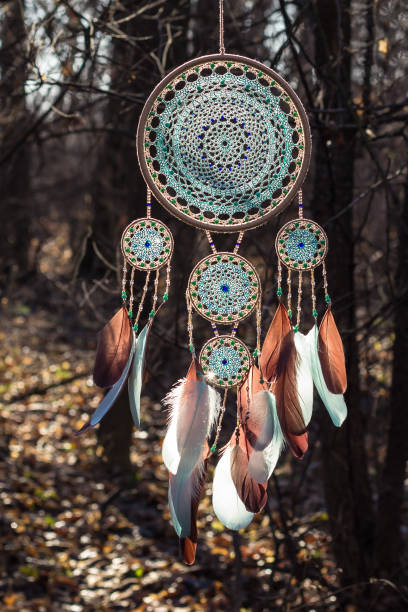 istock Handmade dream catcher with feathers threads and beads rope hanging 1200937321