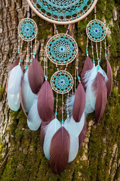 istock Handmade dream catcher with feathers threads and beads rope hanging 1200937330