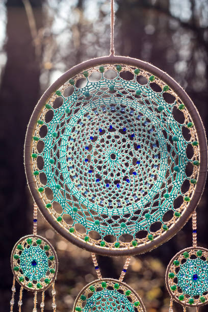 istock Handmade dream catcher with feathers threads and beads rope hanging 1200937357