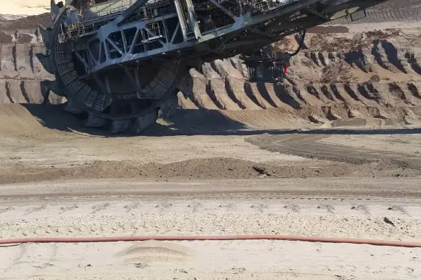 The work of a bucket wheel excavator in a quarry. Ore mining in a quarry.