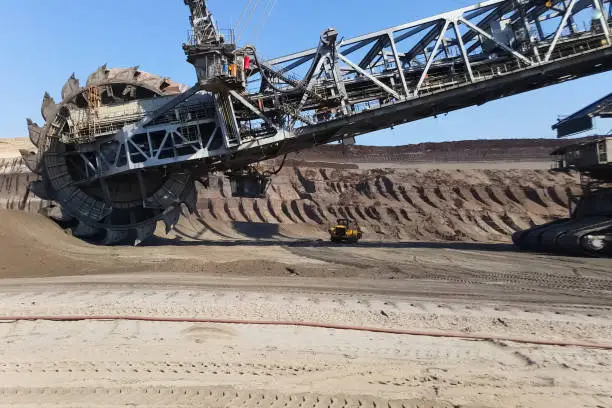 The work of a bucket wheel excavator in a quarry. Ore mining in a quarry.