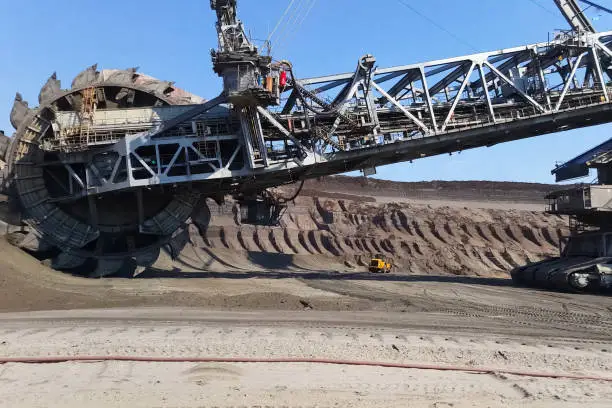 The work of a bucket wheel excavator in a quarry. Ore mining in a quarry.