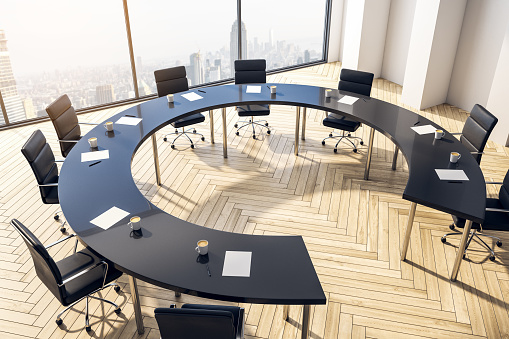Top view furnished conference room with round table, chairs and large window overlooking the city. 3D Rendering