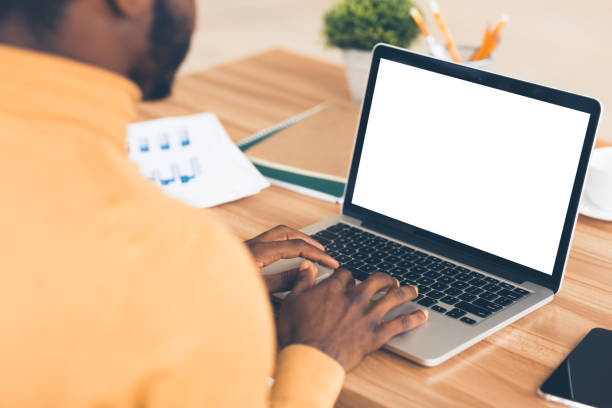 istock Afro businessman typing on lapop financial report 1200938699