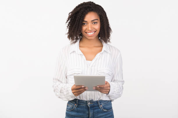istock Smiling afro girl standing with tablet at studio 1200938835