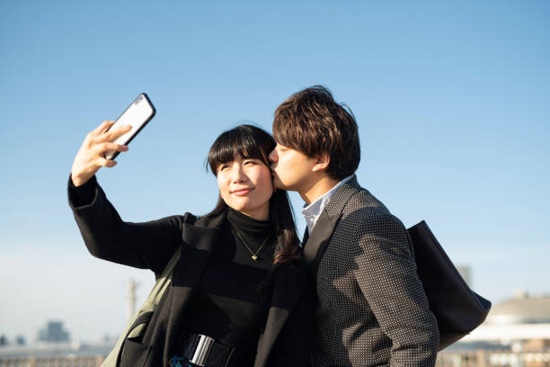 istock Married couple taking selfie on sky background 1200938872
