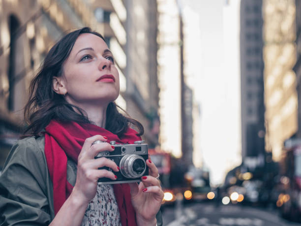 istock Young girl with a retro camera 1200938919