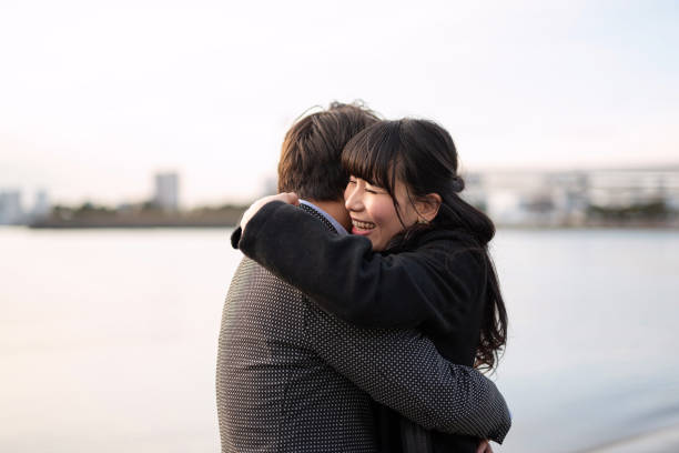 istock Married couple embracing on beach at dusk 1200939045