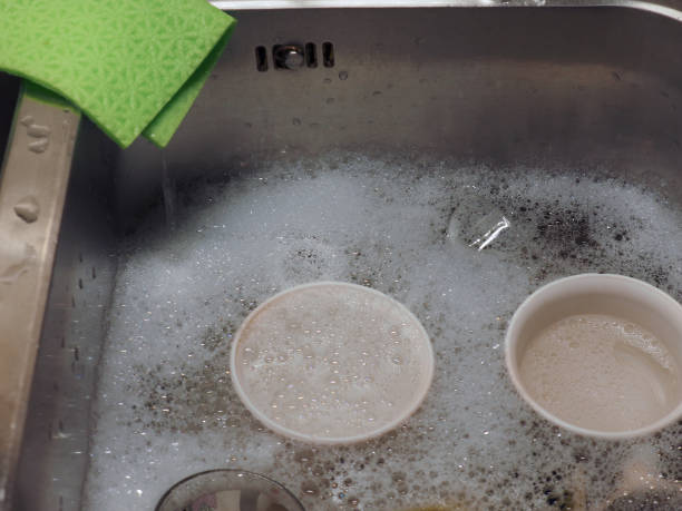 istock hand dish washing in kitchen sink with detergent foam 1200939214