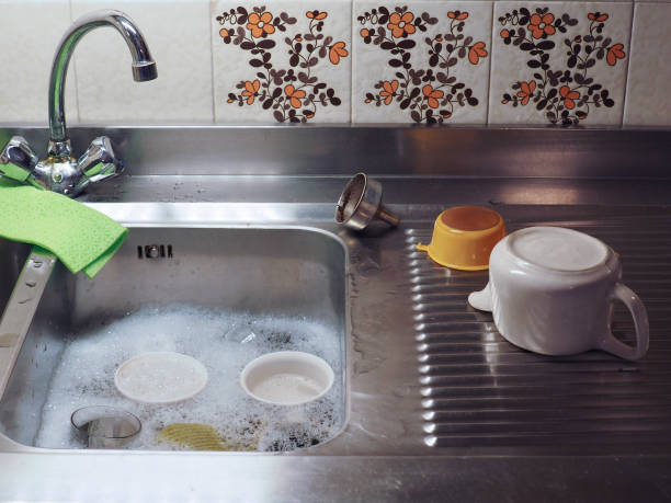 istock hand dish washing in kitchen sink with detergent foam 1200939272