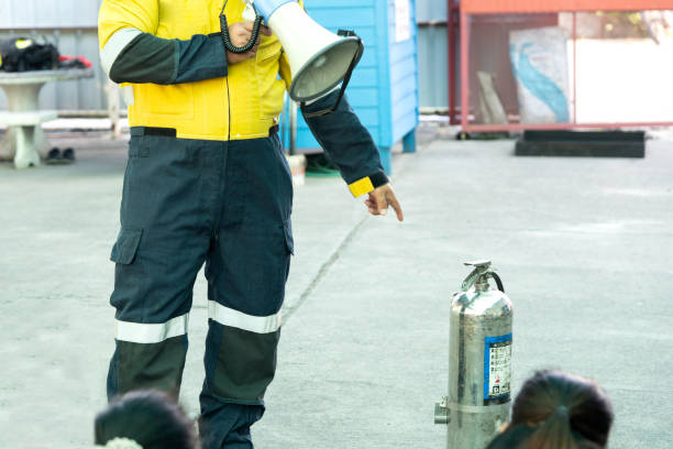 istock Man teaches how to use fire extinguisher to extinguish fire. 1200939307