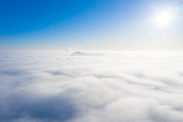 istock shining sun and clear blue sky while flying above the overcast clouds