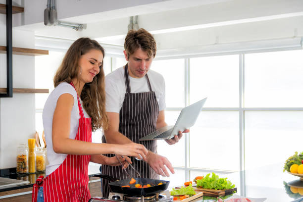 istock Couple is cooking in their kitchen. 1200940261