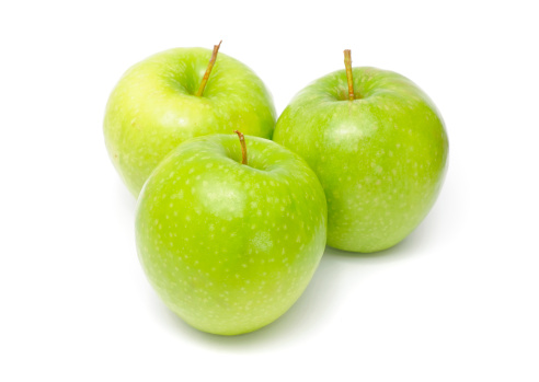 Three green Granny Smith apples isolated on a white background