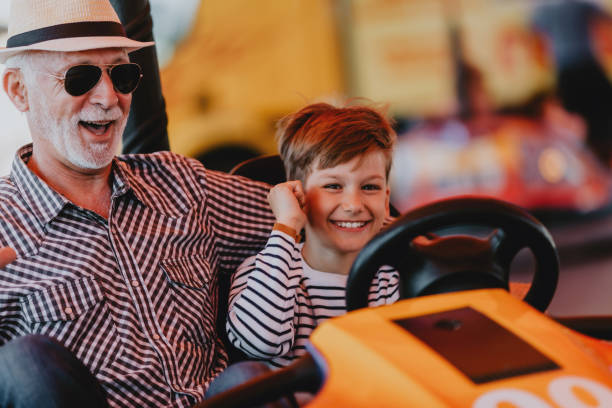 istock Grandfather and grandson amusement park fun 1200942212