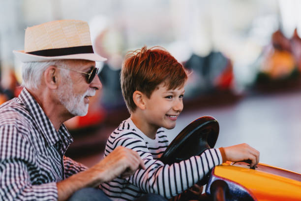 istock Grandfather and grandson amusement park fun 1200942244