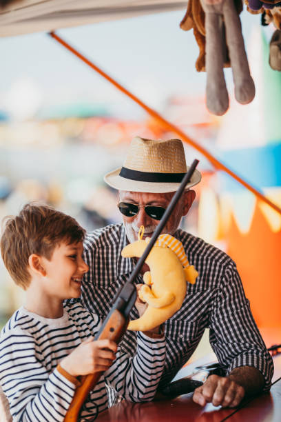 istock Grandfather and grandson amusement park fun 1200942276