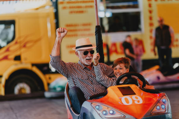 istock Grandfather and grandson amusement park fun 1200942288