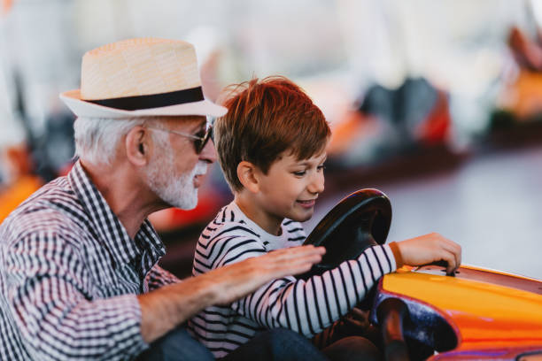 istock Grandfather and grandson amusement park fun 1200942343