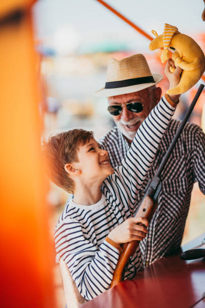 istock Grandfather and grandson amusement park fun 1200942386