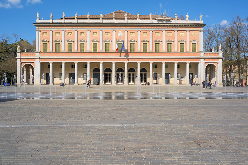 Reggio Emilia, Emilia-Romagna, Italy - March 27, 2019: People at leisure outside the Teatro Valli opera house where the famous tenor Luciano Pavarotti made his debut
