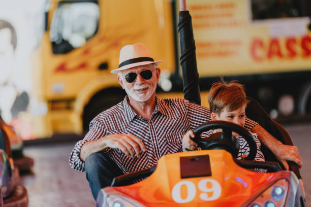 istock Grandfather and grandson amusement park fun 1200942412
