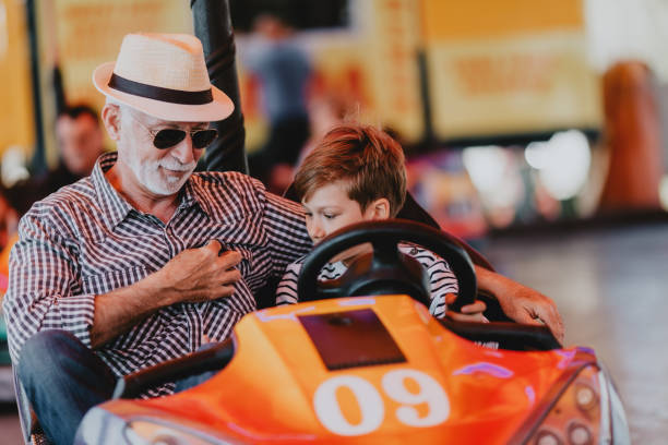 istock Grandfather and grandson amusement park fun 1200942446