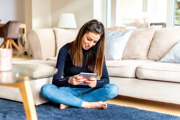 istock Attractive woman with digital tablet relaxing at home 1200945824