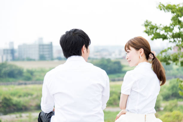 istock Couple sitting and talking outdoors with beautiful scenery 1200946532