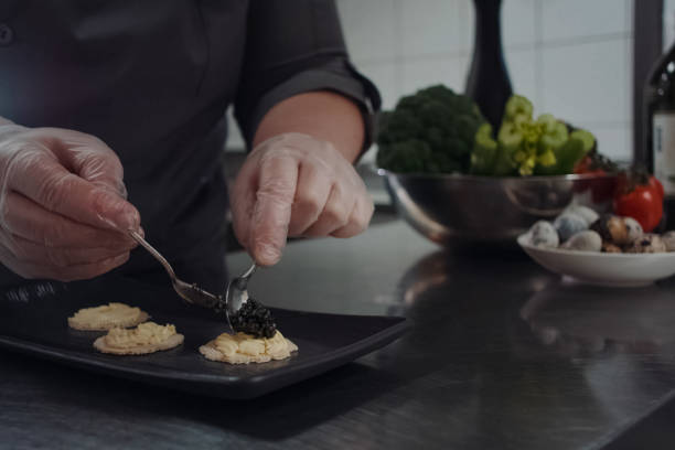 istock cook makes sandwiches with black caviar. 1200946656