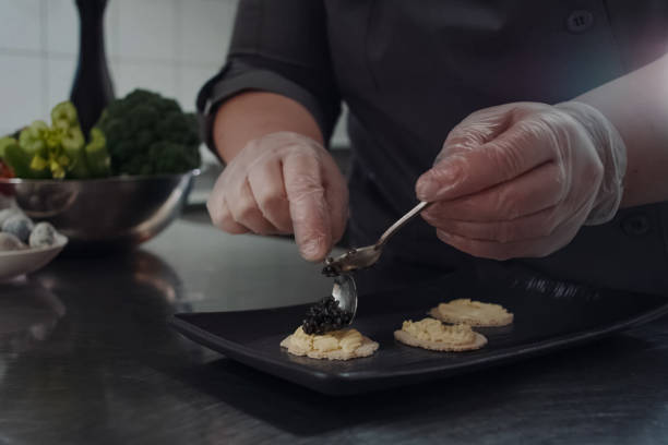 istock cook makes sandwiches with black caviar. 1200946658